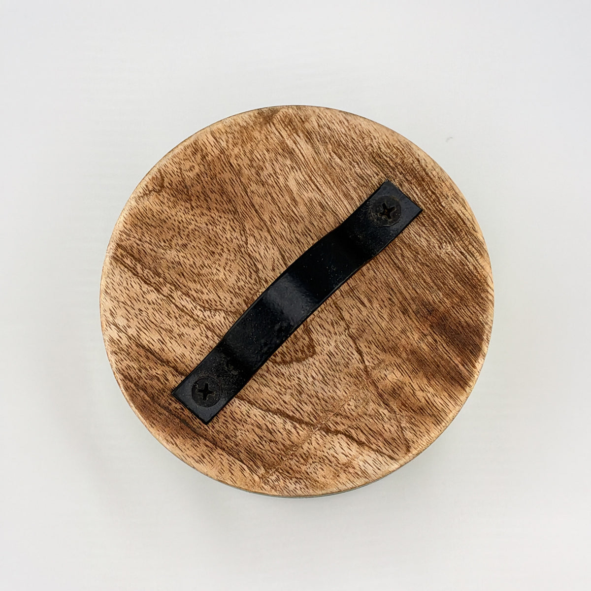 Wooden candle lid with a black leather handle, top view