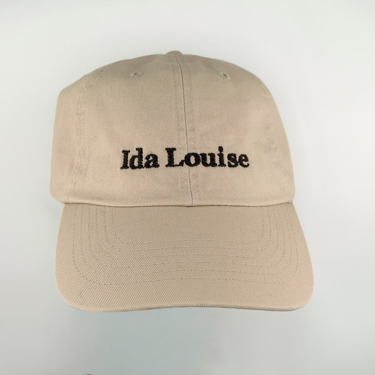 Khaki baseball cap with Ida Louise embroidered in black, front view