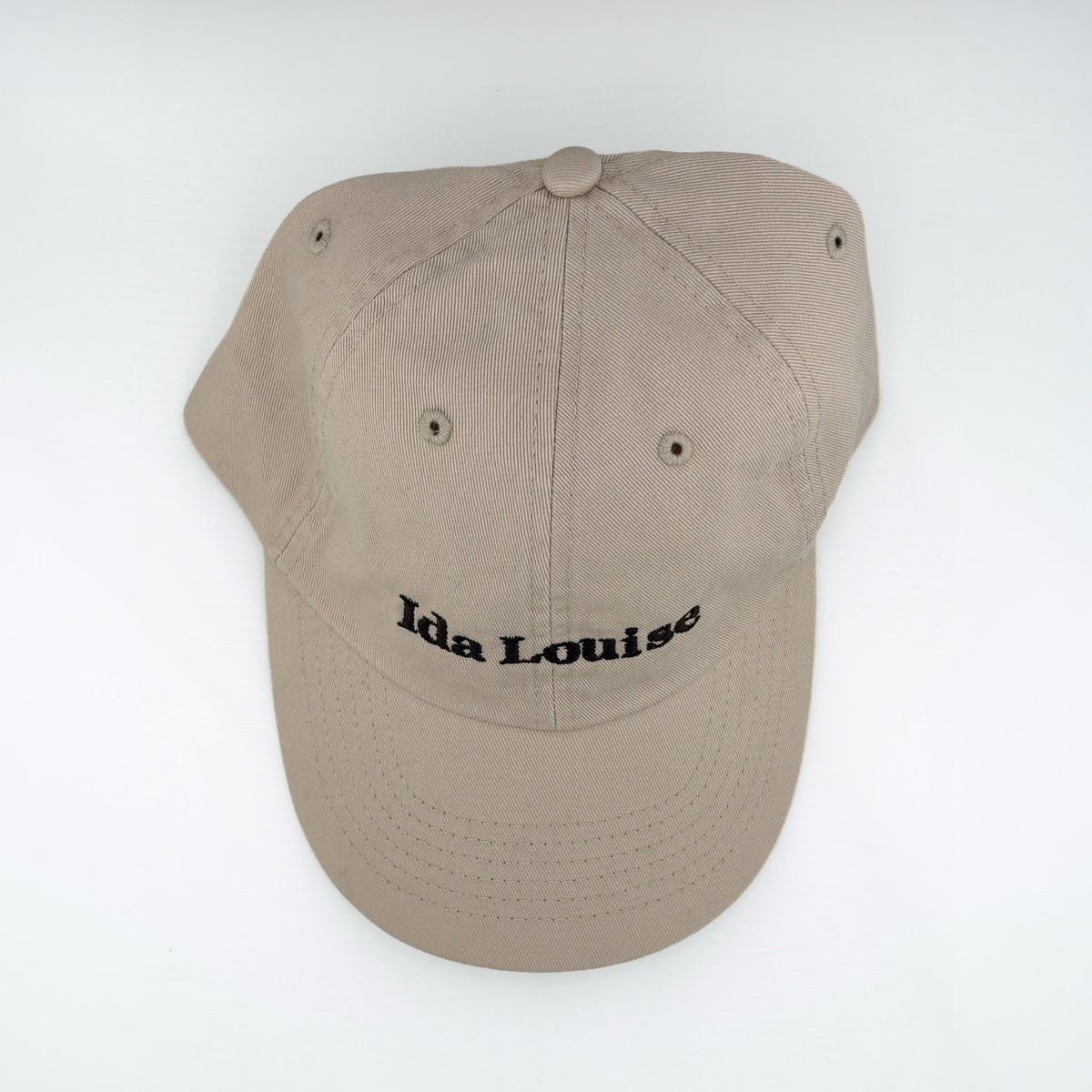 Khaki baseball cap with Ida Louise embroidered in black, top view